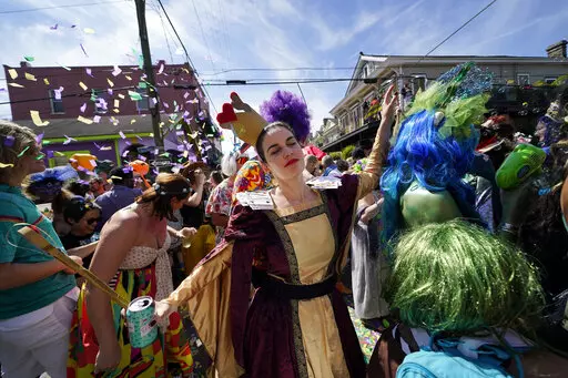 A person dances at the Societe de Sainte Anne parade during Mardi Gras on Tuesday, March 1, 2022, in New Orleans. (AP Photo/Gerald Herbert)