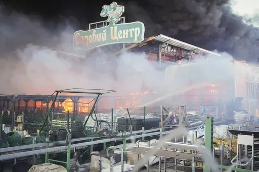 Firefighters put out a fire after two guided bombs hit the Epicenter shopping complex in Kharkiv, Ukraine, Saturday, May 25, 2024. The sign reads "Garden Center". (AP Photo/Andrii Marienko,File)