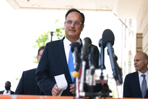 Michael Sussmann, a cybersecurity lawyer who represented the Hillary Clinton presidential campaign in 2016, walks towards the waiting members of the media outside the federal courthouse in Washington, Tuesday, May 31, 2022. Sussmann was acquitted Tuesday of lying to the FBI when he pushed information meant to cast suspicions on Donald Trump and Russia in the run-up to the 2016 election. (AP Photo/Manuel Balce Ceneta)