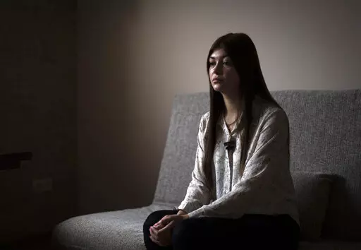 Alina Kapatsyna sits in a house in Dnipro, Ukraine, Friday, Jan. 6, 2023. Men in military uniforms took her mother 45-year-old Vita Hannych away from her house in eastern Ukraine in April. Since the war in Ukraine began, many civilians have been detained by Russian forces and are languishing in jails for months without charges as their relatives seek to find out what's happened to them. (AP Photo/Hanna Arhirova)