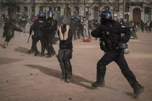 Police officers scuffle with protesters during a demonstration in Lyon, central France, on March 23, 2023. French authorities see the police as protectors ensuring that citizens can peacefully protest President Emmanuel Macron’s contentious retirement age increase. But to human rights advocates and demonstrators who were clubbed or tear-gassed, officers have overstepped their mission. (AP Photo/Laurent Cipriani, File)