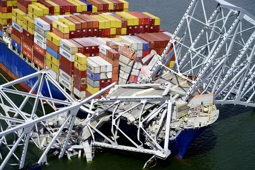 In this aerial image released by the Maryland National Guard, the cargo ship Dali is stuck under part of the structure of the Francis Scott Key Bridge after the ship hit the bridge, March 26, 2024, in Baltimore. (Maryland National Guard via AP, File)