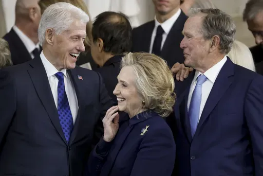 From left, former President Bill Clinton, former Secretary of State Hillary Clinton, and former President George W. Bush, speak following the 60th Presidential Inauguration for President Donald Trump, in the Rotunda of the U.S. Capitol in Washington, Monday, Jan. 20, 2025. (Shawn Thew/Pool photo via AP)