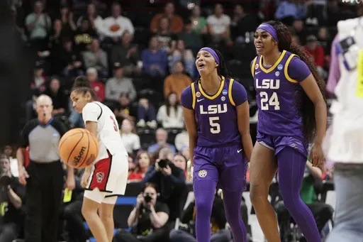 LSU forward Sa'Myah Smith (5) and forward Aneesah Morrow (24) celebrate after their win over North Carolina State in the Sweet 16 of the NCAA college basketball tournament, Friday, March 28, 2025, in Spokane, Wash. (AP Photo/Young Kwak)