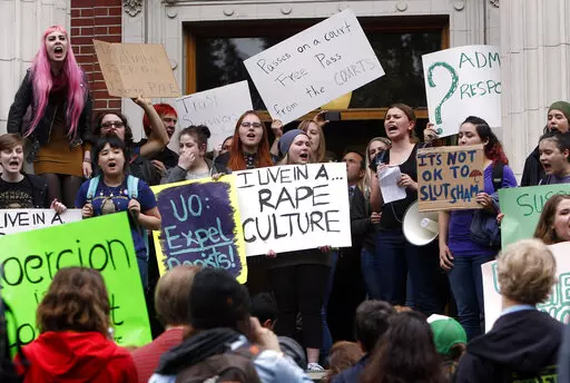 University of Oregon students and staff protest on the steps of Johnson Hall on the UO campus in Eugene, Ore. Thursday May 8, 2014, against sexual violence in the wake of allegations of rape brought against three UO basketball players by a fellow student. (AP Photo/The Register-Guard, Chris Pietsch, File)