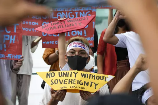 Protesters hold slogans to mark the 6th anniversary of the issuance of the 2016 decision by an arbitration tribunal set up under the U.N. Convention of the Law of the Sea after the Philippines complained against China's increasingly aggressive actions in the disputed sea during a rally outside the Chinese consulate in Makati, Philippines, Tuesday, July 12, 2022. U.S. Secretary of State Antony Blinken renewed a call to China to comply with a 2016 arbitration ruling that invalidated Beijing's vast