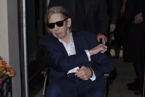 Shane MacGowan poses for photographers upon arrival at the Shane MacGowan, The Eternal Buzz & The Crock of Gold Exhibition in London, Tuesday, Oct. 11, 2022. Shane MacGowan, lead singer of The Pogues and best known for 'Fairytale of New York,' has died at 65, his wife said on Thursday, Nov. 30, 2023. (Photo by Scott Garfitt/Invision/AP, File)