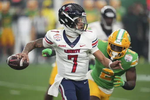 Liberty quarterback Kaidon Salter (7) scrambles during the first half on the NCAA Fiesta Bowl college football game against Oregon, on Jan. 1, 2024, in Glendale, Ariz. Liberty is favored to repeat as Conference USA champion with Western Kentucky and Jacksonville State picked behind the Flames, according to a poll of media members who cover the league. (AP Photo/Ross D. Franklin, File)
