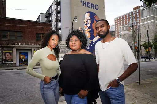 D'Zhane Parker, left, Cicley Gay, center, and Shalomyah Bowers pose for a portrait on Friday, May 13, 2022, in Atlanta. (AP Photo/Brynn Anderson)