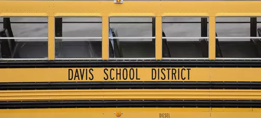 A Davis School District bus sits at the Bus Farm in Farmington, Utah, in this undated photo. A Black woman hired by the northern Utah school district to investigate racial harassment complaints a year after a 10-year-old Black student died by suicide says that she, too, experienced discrimination from district officials. Joscelin Thomas, a former coordinator in the Davis School District's equal opportunity office, alleges in a federal lawsuit that district administrators treated her “as if she