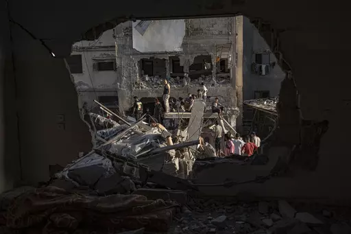 Palestinians look at the destruction after Israeli strikes on the Gaza Strip in Khan Younis, Saturday, Now. 4, 2023. (AP Photo/Fatima Shbair)