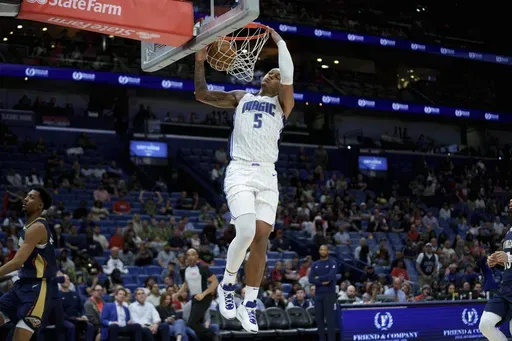 Orlando Magic forward Paolo Banchero (5) breaks free for a dunk against New Orleans Pelicans guard Trey Murphy III (25) during the second half of an NBA basketball game in New Orleans, Thursday, March 13, 2025. (AP Photo/Matthew Hinton)
