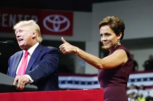Arizona Republican candidate for governor, Kari Lake, gives a thumbs up to the crowd as former President Donald Trump speaks at a Save America rally on July 22, 2022, in Prescott, Ariz. Lake, a well-known former television anchor, has delighted the segments of the GOP base that have long been at odds with their party’s establishment and want their leaders to confront Democrats, not compromise with them. (AP Photo/Ross D. Franklin, File)