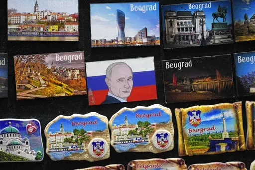 A vendor sells refrigerator magnets showing a picture of Russian President Vladimir Putin, on main pedestrian street in downtown Belgrade, Serbia, Monday, Jan. 16, 2023. Since the start of the war in Ukraine, about 200,000 Russians have left their homeland for Serbia, with many seeking a new life in a fraternal Slavic country free from Kremlin oppression. The Balkan country is a close ally of Moscow, with historic, religious and cultural ties, and Russia backs Serbia’s claim over its former pr