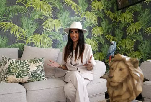 Sara Al Madani, an Emirati serial entrepreneur, talks during an interview with the Associated Press at her house, in Dubai, United Arab Emirates, Wednesday, May 25, 2022. The world famous reality-show empire "Real Housewives" is coming to the flashy city-state of Dubai for the franchise's first international series premiering this week. (AP Photo/Kamran Jebreili)