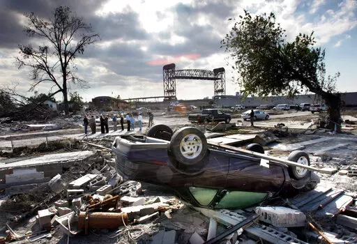 Members of the Louisiana Recovery Authority tour New Orleans' hurricane-ravaged Lower 9th Ward, Wednesday, Oct. 26, 2005, as much of the 9th Ward was destroyed when the levee broke at the Industrial Canal during Hurricanes Katrina and Rita. Seventeen years after Hurricane Katrina flooded New Orleans, the Army Corps of Engineers has completed an extensive system of floodgates, strengthened levees and other protections. (AP Photo/Robert F. Bukaty, File)