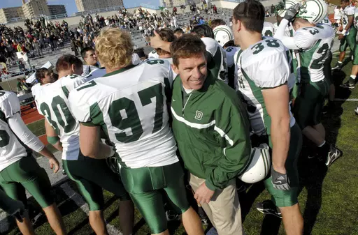 Dartmouth coach Buddy Teevens celebrates with the team after a win over Columbia during college football game Oct. 21, 2006, in New York. Teevens, the innovative Ivy League football coach who brought robotic tackling dummies to Dartmouth practices, died Tuesday, Sept. 19, 2023, of injuries he sustained from a bicycle accident in March. He was 66. School president Sian Leah Beilock and athletic director Mike Harrity announced Teevens' death in a letter to the Dartmouth community. (AP Photo/Paul H