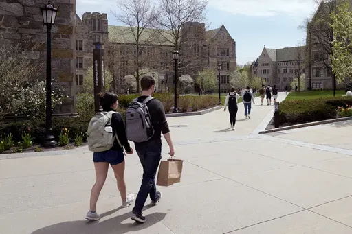 Students walk on the campus of Boston College, Monday, April 29, 2024, in Boston. . (AP Photo/Charles Krupa, File)