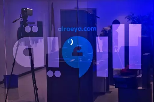 A cleaner sweeps the reception area at the Al Roeya newspaper's offices in Dubai, United Arab Emirates, Sept. 3, 2022. A state-linked newspaper in the United Arab Emirates published a story this summer about a hot-button issue in the country: How Emiratis are coping with high fuel prices. It ended up seeing over 40 people fired and the paper was declared dissolved. The purge at Al Roeya reflects the intense challenges facing local journalists in the autocratic UAE, even as it courts Western medi