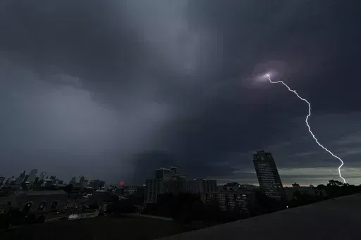 Lightning strikes in the distance as a thunderstorm passes over downtown Kansas City, Mo., July 30, 2023. Tens of millions of Americans stretching from Lincoln, Neb., to Baltimore could face strong thunderstorms Monday night, April 15, 2024, through Wednesday, April 17, with tornadoes possible in some states. (AP Photo/Charlie Riedel, File)