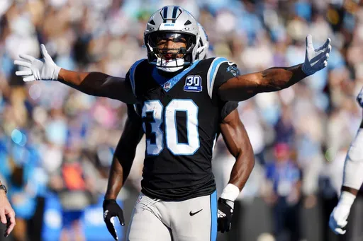 Carolina Panthers running back Chuba Hubbard celebrates after scoring against the New Orleans Saints during the second half of an NFL football game Sunday, Nov. 3, 2024, in Charlotte, N.C. (AP Photo/Jacob Kupferman)