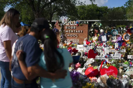 People visit a memorial at Robb Elementary School in Uvalde, Texas, on June 2, 2022, to pay their respects to the victims killed in a school shooting. A legislative committee investigating the deadly shooting at the Texas elementary school is set to hear more testimony from law enforcement officers on Monday, June 20, 2022. (AP Photo/Jae C. Hong, File)