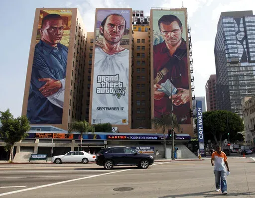 A "Grand Theft Auto V" billboard is displayed at Figueroa Hotel on Sept. 10, 2013, in Los Angeles. Video game producer Rockstar Games said Monday, Sept. 19, 2022, that early development footage from the next version of its popular title Grand Theft Auto was stolen in the hack of its network. (AP Photo/Nick Ut, File)