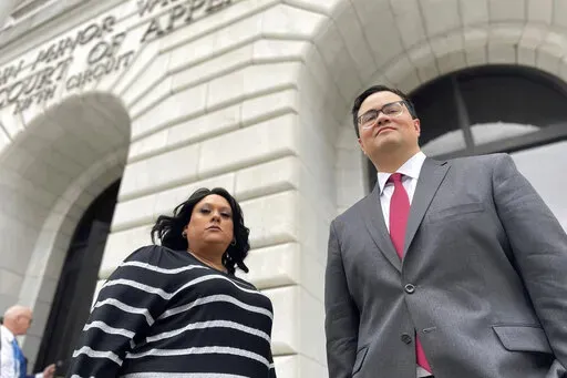 Priscilla Villarreal, an online journalist from Laredo, Texas, stands outside the 5th U.S. Circuit Court of Appeals building in New Orleans on Wednesday, Jan. 25, 2023, with her attorney, J.T. Morris, after the court heard arguments in Villarreal's lawsuit against Laredo and Webb County, Texas, authorities. Her suit says she was wrongfully arrested by Laredo and Webb County authorities in 2017 for seeking information from police. The criminal charge against her was dismissed by a Texas judge in 