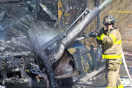 Firefighers work the scene after a tanker truck overturned on U.S. 15 in Frederick, Md., on Saturday, March 4, 2023. The fiery crash killed the driver and burned vehicles and homes in Frederick, about an hour's drive west of Baltimore, authorities said. (Bill Green /The Frederick News-Post via AP)