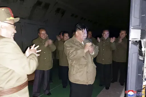 In this photo provided by the North Korean government, North Korean leader Kim Jong Un, center, supervises tests of long-range cruise missiles at an undisclosed location in North Korea Wednesday, Oct. 12, 2022. Independent journalists were not given access to cover the event depicted in this image distributed by the North Korean government. The content of this image is as provided and cannot be independently verified. Korean language watermark on image as provided by source reads: "KCNA" which i