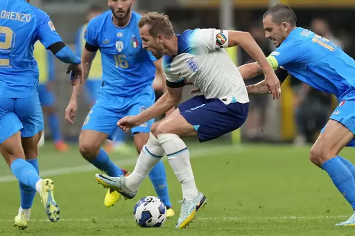 England's Harry Kane, center, wearing a rainbow armband, controls the ball during the UEFA Nations League soccer match between Italy and England at the San Siro stadium, in Milan, Italy, on Sept. 23, 2022. The anti-discrimination “One Love” captain’s armband controversially denied to teams at the men’s World Cup in Qatar will be worn at the Women’s World Cup next month in an amended version now approved by FIFA. FIFA has unveiled eight campaign armbands on Friday, June 30, 2023. (AP Ph