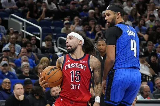 New Orleans Pelicans guard Jose Alvarado (15) looks to pass the ball as he gets around Orlando Magic guard Jalen Suggs (4) during the second half of an NBA basketball game, Friday, Nov. 8, 2024, in Orlando, Fla. (AP Photo/John Raoux)