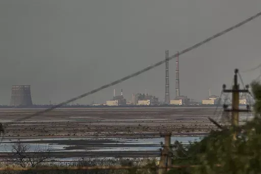 The Zaporizhzhia nuclear power plant, Europe's largest, is seen in the background of the shallow Kakhovka Reservoir after the dam collapse, in Energodar, Russian-occupied Ukraine, Tuesday, June 27, 2023. The U.N. atomic watchdog said in a statement late Monday, July 24, 2023, its staff at Ukraine’s Russian-occupied Zaporizhzhia Nuclear Power Plant report seeing anti-personnel mines around the site. The report comes as Kyiv pursues a counteroffensive against the Kremlin’s entrenched forces af