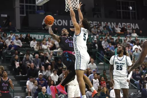 Florida Atlantic guard Alijah Martin (15) shoots a basket in front of Tulane forward Collin Holloway (5) during the first half of an NCAA college basketball game in New Orleans, Thursday, Jan. 11, 2024. (AP Photo/Tyler Kaufman)
