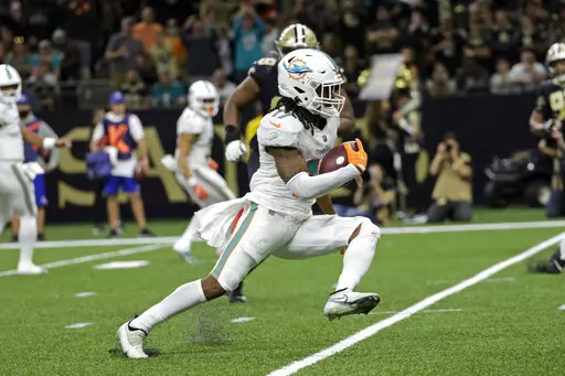 Miami Dolphins' Jaylen Waddle (17) runs for a touchdown during the second half of an NFL football game against the New Orleans Saints Monday, Dec. 27, 2021, in New Orleans. (AP Photo/Derick Hingle)