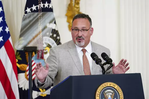 Education Secretary Miguel Cardona speaks during the 2022 National and State Teachers of the Year event in the East Room of the White House in Washington, April 27, 2022. The Biden administration says it will forgive all remaining federal student debt for former students of the for-profit Corinthian Colleges chain. “As of today, every student deceived, defrauded and driven into debt by Corinthian Colleges can rest assured that the Biden-Harris Administration has their back and will discharge t