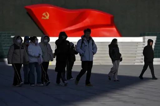 People walk past a sculpture of the Chinese Communist Party flag at the Museum of the Communist Party of China, in Beijing on Jan. 14, 2025. (AP Photo/Andy Wong)