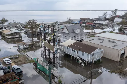 Flood waters surround storm damaged homes on Aug. 31, 2021, in Lafourche Parish, La., as residents try to recover from the effects of Hurricane Ida. Louisiana and nine other states filed a lawsuit against the federal government Thursday, June 1, 2023, to block sharp impending national flood insurance rate increases slated to be phased in over the coming years, saying the steeper costs could cost some people their homes. (AP Photo/Steve Helber)