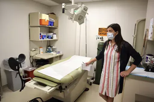Chief Nurse Executive Danielle Maness stands in an empty examination room that was used to perform abortions at the Women's Health Center of West Virginia in Charleston, W.Va., June 29, 2022. A new abortion provider, the Women’s Health Center of Maryland, is opening this year in the Democratic-controlled state — just across from deeply conservative West Virginia, where state lawmakers recently passed a near-total abortion ban. (AP Photo/Leah Willingham, File)