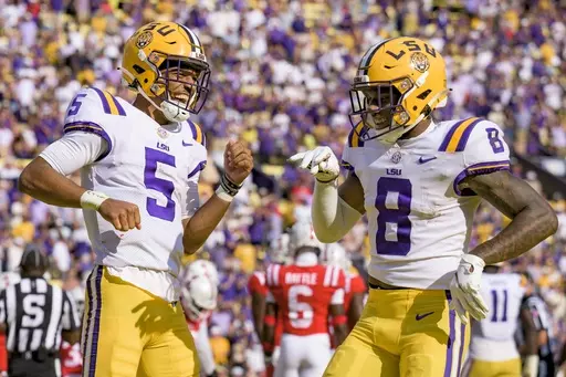 LSU quarterback Jayden Daniels (5) celebrates a touchdown with wide receiver Malik Nabers (8) during the first half of an NCAA college football game against Mississippi in Baton Rouge, La., Saturday, Oct. 22, 2022. LSU opens their season at Florida State on Sept. 3. (AP Photo/Matthew Hinton, File)