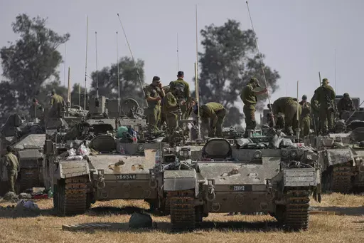 Israeli soldiers are seen at a staging ground near the border with the Gaza Strip, in southern Israel, Tuesday, April 30, 2024. (AP Photo/Tsafrir Abayov)
