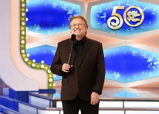This image released by CBS Entertainment shows host Drew Carey on the set of "The Price Is Right." The long-running game show is hitting the road with the “Come On Down Tour", making 50 stops on a coast-to-coast tour for anyone who can’t make the trip to the Los Angeles studio. The tour will kick off Friday at the Santa Monica Pier and will make stops in such cities as Denver, Dallas, New Orleans, Nashville and St. Louis. (Adam Torgerson/CBS Entertainment via AP)