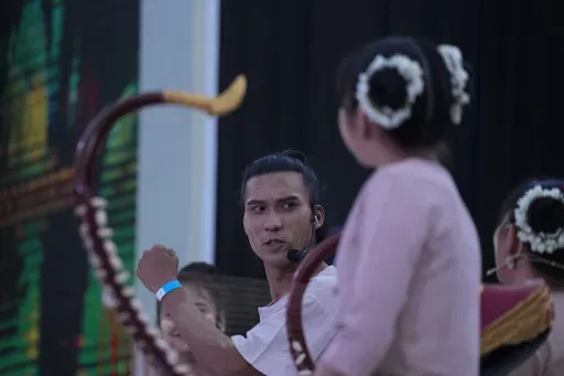 Artist with traditional attire put Thanakha, traditional make-up, on her face as she takes part in performance competition show aiming to submit the traditional culture of Thanakha to UNESCO's Intangible Cultural Heritage of Humanity, Wednesday, Feb.12, 2025 in Yangon, Myanmar. (AP Photo/Thein Zaw)
