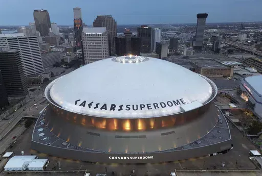 The Superdome stands with the New Orleans skyline in the background after an NFL football game between the New Orleans Saints and the Atlanta Falcons, Jan. 7, 2024, in New Orleans. The state commission that oversees the Superdome and the Saints are at odds over the club's contribution to the costs of renovations scheduled for completion before the stadium hosts the next Super Bowl. (AP Photo/Tyler Kaufman, File)