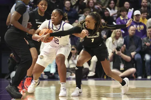 Vanderbilt guard Mikayla Blakes (1) tries to steal the ball from LSU guard Mikaylah Williams (12) during the first half of an NCAA college basketball game in Baton Rouge, La., Monday, Jan. 13, 2025. (AP Photo/Peter Forest)
