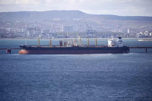 An oil tanker is moored at the Sheskharis complex, part of Chernomortransneft JSC, a subsidiary of Transneft PJSC, in Novorossiysk, Russia, on Oct. 11, 2022. A Russian official says the country will will cut oil production by 500,000 barrels per day next month in response to the West capping the price of its crude over the war in Ukraine. According to multiple Russian news media reports, Deputy Prime Minister Alexander Novak said Friday, Feb. 10, 2023 that “we will not sell oil to those who di