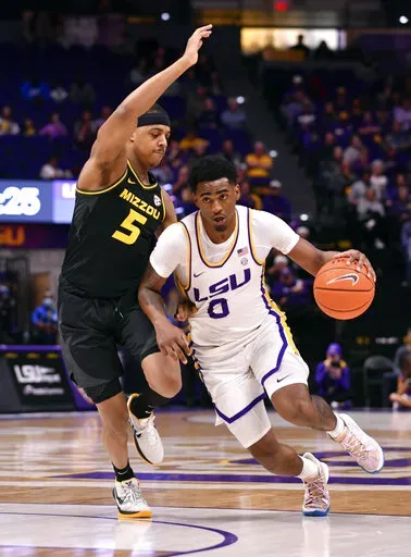 LSU guard Brandon Murray (0) drives the ball past Missouri guard Jarron Coleman (5) during an NCAA college basketball game Saturday, Feb. 26, 2022 in Baton Rouge, La. (Hillary Scheinuk/The Advocate via AP)