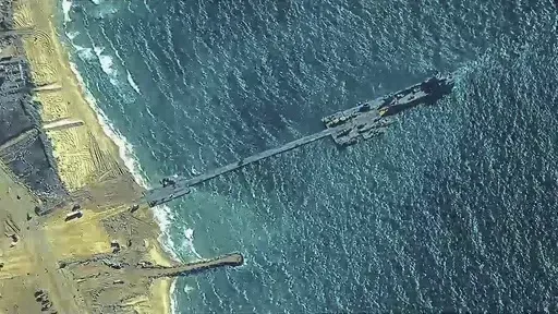 The image provided by U.S, Central Command, shows U.S. Army soldiers assigned to the 7th Transportation Brigade (Expeditionary), U.S. Navy sailors assigned to Amphibious Construction Battalion 1, and Israel Defense Forces placing the Trident Pier on the coast of Gaza Strip on Thursday, May 16, 2024. The temporary pier is part of the Joint Logistics Over-the-Shore capability. The U.S. military finished installing the floating pier on Thursday, with officials poised to begin ferrying badly needed 