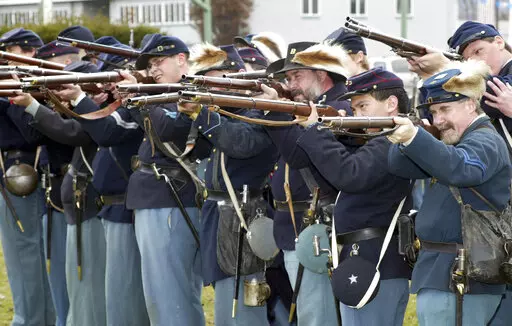 FILE — Members of the Mifflin Guard, consisting of re-enactors from New York, New Jersey and Pennsylvania, rehearse some battlefield tactics, on March 28, 2004, on the grounds of the Kingston Armory in Wilkes-Barre Pa. Some historical battle re-enactors in New York are holding their musket fire because of worries over the state's new gun law that declares parks, government property and a long list of other places off limits to guns beginning in Sept. 2022. (Dave Scherbenco/The Citizens' Voice 