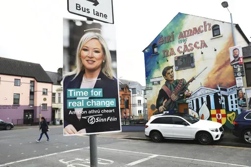 A Sinn Fein election poster hangs from a lamp post in West Belfast, Northern Ireland, Tuesday, May 3, 2022. Sinn Fein, a force in Irish republicanism on both sides of the Irish border looks likely to become the largest party in the assembly, according to polls ahead of the May 5, 2022 local elections. (AP Photo/Peter Morrison)